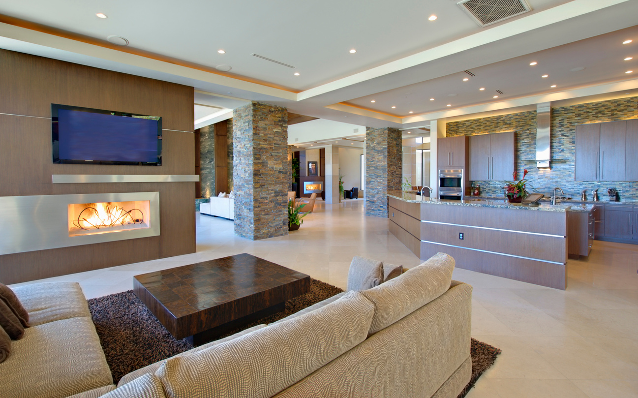 Open planned interior with furniture  a television and a kitchen
